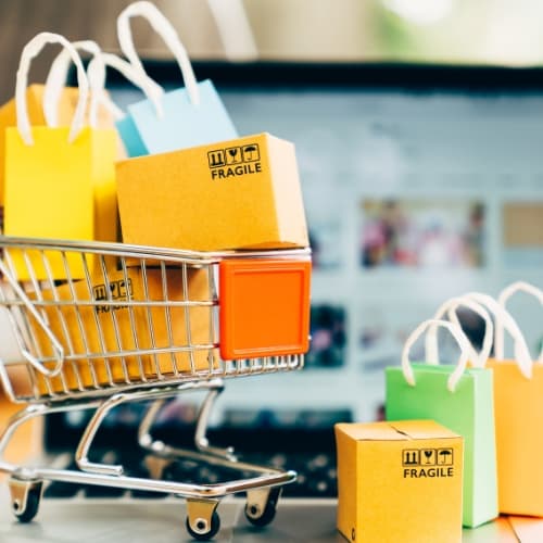 product-package-boxes-shopping-bag-cart-with-laptop-online-shopping-delivery-concept